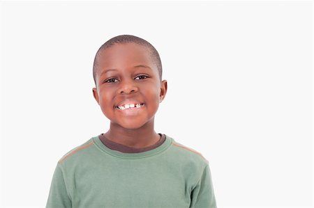 simsearch:6107-06117700,k - Smiling boy posing against a white a background Photographie de stock - Aubaine LD & Abonnement, Code: 400-05895628