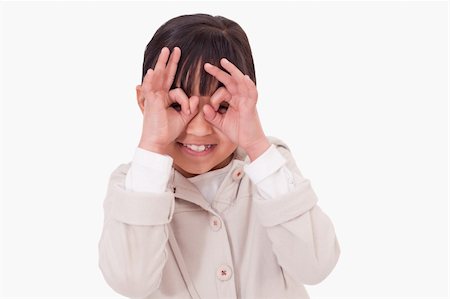 funny looking girls with glasses - Girl putting her fingers around her eyes against a white background Stock Photo - Budget Royalty-Free & Subscription, Code: 400-05895648