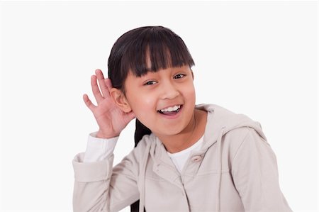 fingers in ears - Girl pricking up her ear against a white background Stock Photo - Budget Royalty-Free & Subscription, Code: 400-05895649