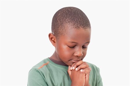 simsearch:400-04152433,k - Calm boy praying against a white background Photographie de stock - Aubaine LD & Abonnement, Code: 400-05895640