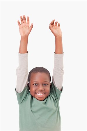 simsearch:400-04343310,k - Portrait of a boy raising his arms against a white background Photographie de stock - Aubaine LD & Abonnement, Code: 400-05895641