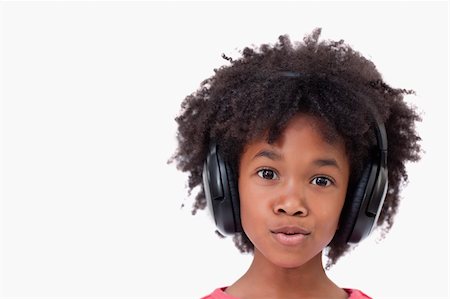 Close up of a girl listening to music against a white background Stock Photo - Budget Royalty-Free & Subscription, Code: 400-05895694