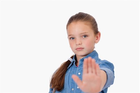 simsearch:400-06635276,k - Girl saying stop with her hand against a white background Photographie de stock - Aubaine LD & Abonnement, Code: 400-05895717