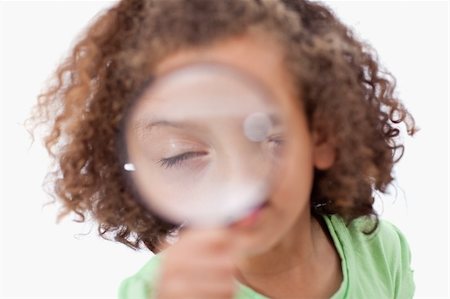simsearch:400-04554899,k - Cute girl looking through a magnifying glass against a white background Stock Photo - Budget Royalty-Free & Subscription, Code: 400-05895732