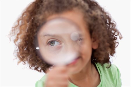 simsearch:400-04554899,k - Smiling girl looking through a magnifying glass against a white background Stock Photo - Budget Royalty-Free & Subscription, Code: 400-05895733