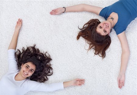 simsearch:400-04982004,k - Happy people framing white rug textured copy space - teenagers on the floor Stock Photo - Budget Royalty-Free & Subscription, Code: 400-05896195