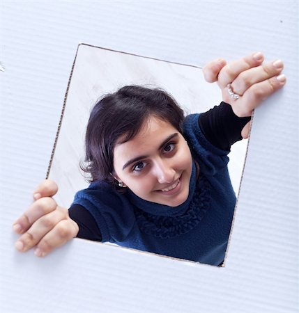 Teenager girl breaking out of her cardboard box - open mind concept Stock Photo - Budget Royalty-Free & Subscription, Code: 400-05896198