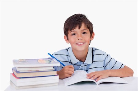 people reading books drawing - Boy doing his homework against a white background Stock Photo - Budget Royalty-Free & Subscription, Code: 400-05896304