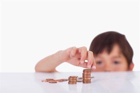 Boy counting his change against a white background Stock Photo - Budget Royalty-Free & Subscription, Code: 400-05896306