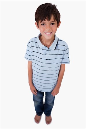 simsearch:6107-06117685,k - Portrait of a boy smiling at the camera against a white background Foto de stock - Super Valor sin royalties y Suscripción, Código: 400-05896312