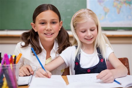 simsearch:6109-06196438,k - Pupils working together on an assignment in a classroom Photographie de stock - Aubaine LD & Abonnement, Code: 400-05896367