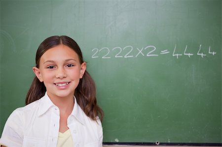 simsearch:400-05894745,k - Schoolgirl posing in front of a chalkboard in a classroom Stockbilder - Microstock & Abonnement, Bildnummer: 400-05896389