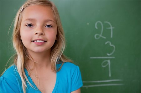 simsearch:400-05902406,k - Little schoolgirl posing in front of a chalkboard Stock Photo - Budget Royalty-Free & Subscription, Code: 400-05896495
