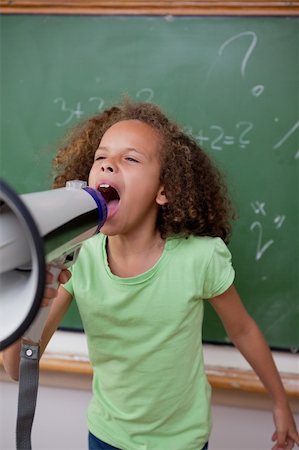 simsearch:400-09223567,k - Portrait of a cute schoolgirl screaming through a megaphone in a classroom Stock Photo - Budget Royalty-Free & Subscription, Code: 400-05896491