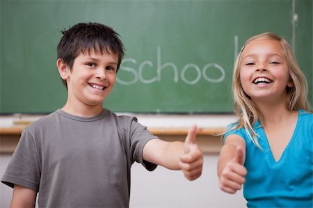 Happy pupils posing with the thumb up in a classroom Stock Photo - Budget Royalty-Free & Subscription, Code: 400-05896516