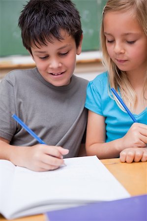 simsearch:400-08937370,k - Portrait of smiling pupils working together in a classroom Stock Photo - Budget Royalty-Free & Subscription, Code: 400-05896525