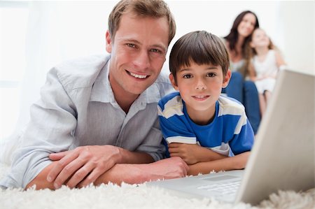 simsearch:400-05897773,k - Boy with his father using laptop together on the carpet Stock Photo - Budget Royalty-Free & Subscription, Code: 400-05896580