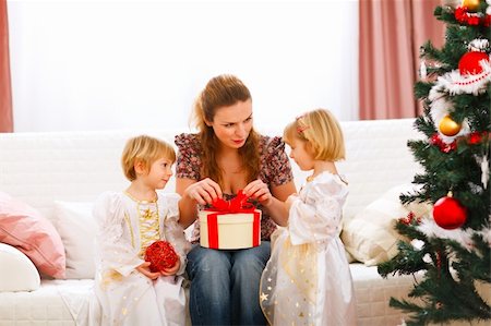 Mother opening gift presented by twins girl Stock Photo - Budget Royalty-Free & Subscription, Code: 400-05896838