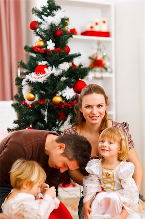 decor home new year - Parents with two daughters spending time near Christmas tree Stock Photo - Budget Royalty-Free & Subscription, Code: 400-05896845