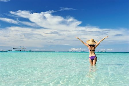 Girl on a tropical beach with outstretched arms Stock Photo - Budget Royalty-Free & Subscription, Code: 400-05897539