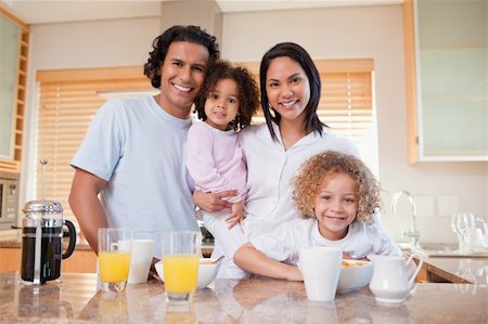 simsearch:400-04708507,k - Happy young family standing in the kitchen together Stock Photo - Budget Royalty-Free & Subscription, Code: 400-05897717