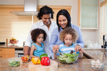 Young family preparing salad together in the kitchen Stock Photo - Budget Royalty-Free & Subscription, Code: 400-05897755