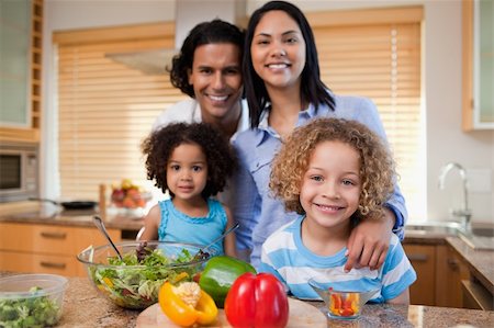 Young family preparing salad together Stock Photo - Budget Royalty-Free & Subscription, Code: 400-05897756