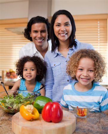 Young family with salad together in the kitchen Stock Photo - Budget Royalty-Free & Subscription, Code: 400-05897757