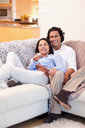 Happy young couple watching television together Stock Photo - Budget Royalty-Free & Subscription, Code: 400-05897770