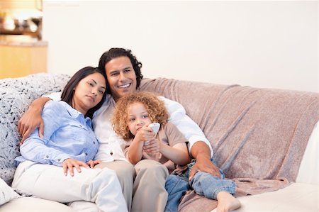 simsearch:400-05897773,k - Young family watching television together Stock Photo - Budget Royalty-Free & Subscription, Code: 400-05897773