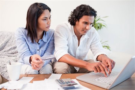 Young couple checking their bank accounts online Stock Photo - Budget Royalty-Free & Subscription, Code: 400-05897912