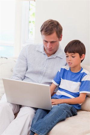 simsearch:400-05897773,k - Young father and son surfing the internet together Stock Photo - Budget Royalty-Free & Subscription, Code: 400-05898108