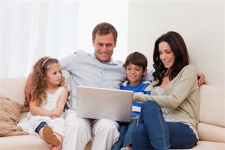 simsearch:400-05897773,k - Young family surfing the internet together Stock Photo - Budget Royalty-Free & Subscription, Code: 400-05898112