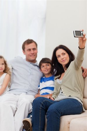 simsearch:400-05897773,k - Young mother taking family photograph on the sofa Stock Photo - Budget Royalty-Free & Subscription, Code: 400-05898161