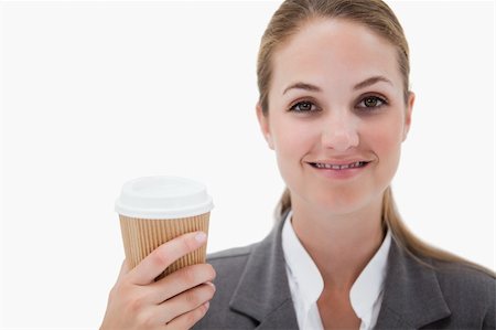 simsearch:400-04188263,k - Businesswoman holding a takeaway coffee against a white background Foto de stock - Super Valor sin royalties y Suscripción, Código: 400-05898180