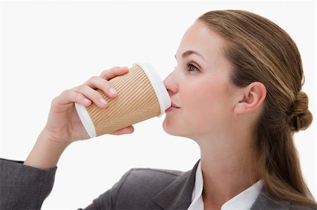 simsearch:400-04188263,k - Businesswoman drinking a takeaway coffee against a white background Foto de stock - Super Valor sin royalties y Suscripción, Código: 400-05898181