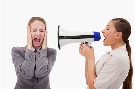 Young manager yelling at her employee through a megaphone against a white background Stock Photo - Budget Royalty-Free & Subscription, Code: 400-05898215