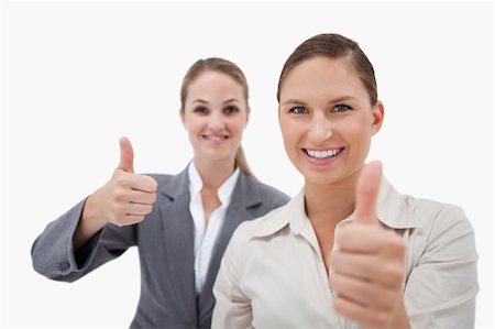simsearch:400-05898224,k - Sales persons posing with the thumb up against a white background Foto de stock - Royalty-Free Super Valor e Assinatura, Número: 400-05898210
