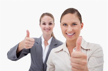 simsearch:400-05898224,k - Smiling sales persons posing with the thumb up against a white background Foto de stock - Royalty-Free Super Valor e Assinatura, Número: 400-05898211