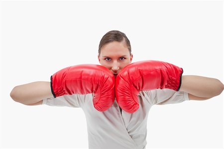 person confused on what to wear - Businesswoman with boxing gloves against a white background Stock Photo - Budget Royalty-Free & Subscription, Code: 400-05898248