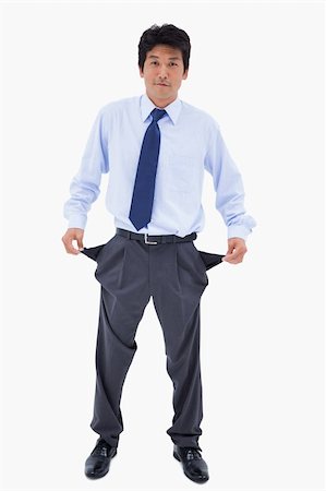 simsearch:400-07305634,k - Portrait of a businessman showing his empty pockets against a white background Photographie de stock - Aubaine LD & Abonnement, Code: 400-05898290