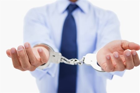 simsearch:694-03330980,k - Close up of a professional's hands with handcuffs against a white background Stock Photo - Budget Royalty-Free & Subscription, Code: 400-05898292