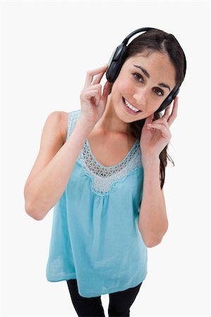 simsearch:400-05717354,k - Portrait of a woman listening to music against a white background Stock Photo - Budget Royalty-Free & Subscription, Code: 400-05898329