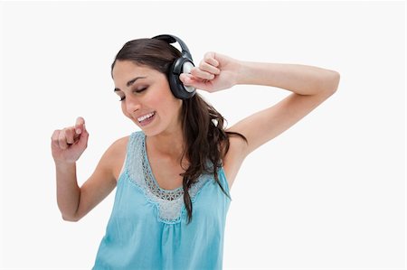 simsearch:400-05717354,k - Woman dancing while listening to music against a white background Stock Photo - Budget Royalty-Free & Subscription, Code: 400-05898337