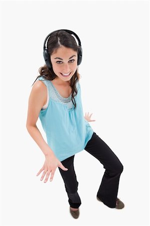 simsearch:400-05717354,k - Portrait of a joyful woman dancing while listening to music against a white background Stock Photo - Budget Royalty-Free & Subscription, Code: 400-05898347