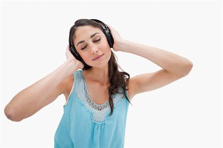 simsearch:400-05717354,k - Woman listening to music against a white background Stock Photo - Budget Royalty-Free & Subscription, Code: 400-05898340