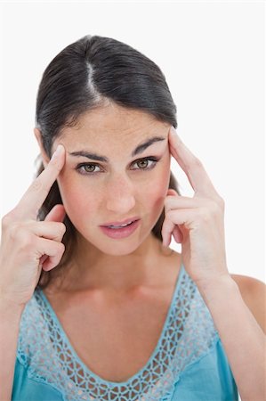 simsearch:400-07485414,k - Portrait of a beautiful woman having a headache against a white background Fotografie stock - Microstock e Abbonamento, Codice: 400-05898392