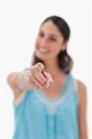 simsearch:400-05895521,k - Portrait of a smiling woman pointing at the viewer against a white background Stock Photo - Budget Royalty-Free & Subscription, Code: 400-05898404