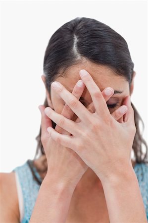 simsearch:400-07624970,k - Portrait of a woman hiding her face against a white background Foto de stock - Super Valor sin royalties y Suscripción, Código: 400-05898400