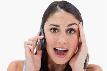 simsearch:400-05717420,k - Shocked woman making a phone call against a white background Foto de stock - Super Valor sin royalties y Suscripción, Código: 400-05898417